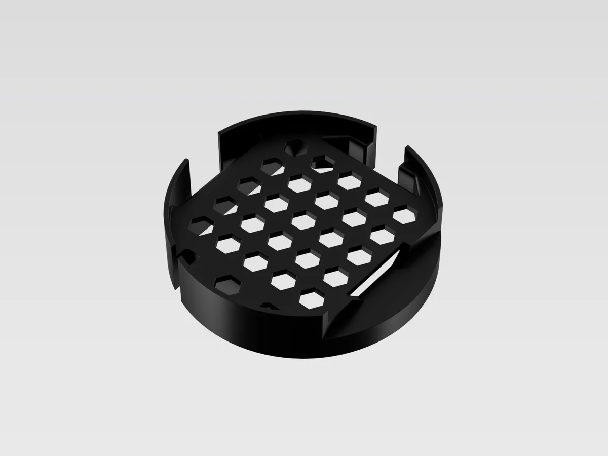 Render of the empty black PCB holder, a round tray with a honeycomb floor.